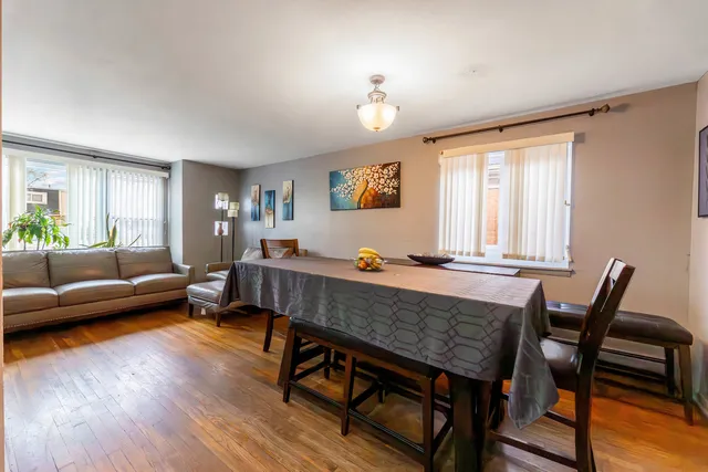 a living room with dining room and wooden floor