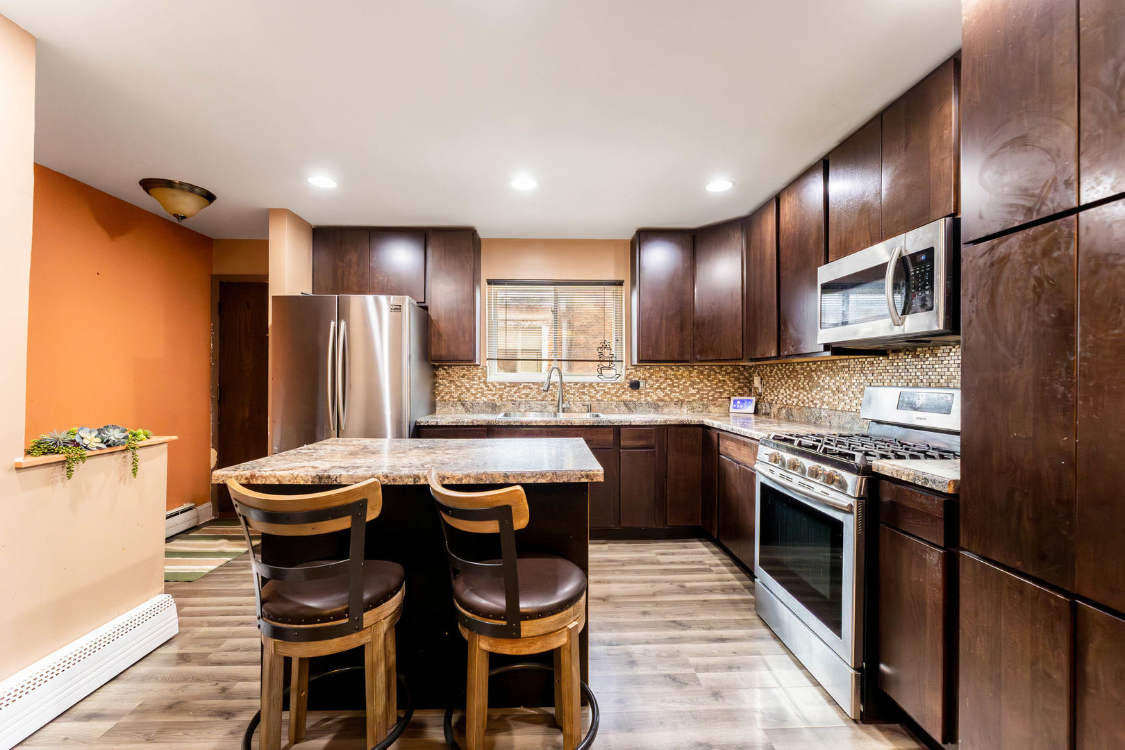 9207 South Halsted Street Chicago, IL 60620 - Photo 5 of 17 a kitchen with stainless steel appliances granite countertop a stove a sink and a refrigerator