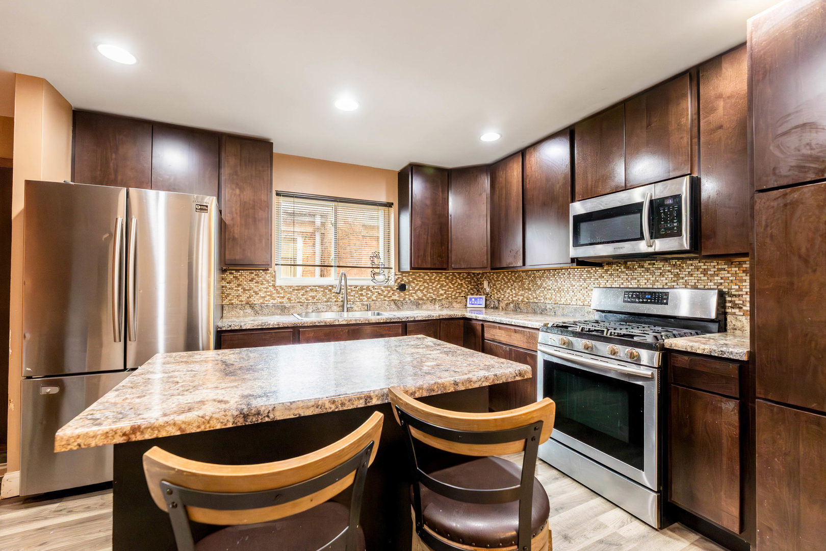 9207 South Halsted Street Chicago, IL 60620 - Photo 6 of 17 a kitchen with stainless steel appliances granite countertop a stove a sink and a refrigerator