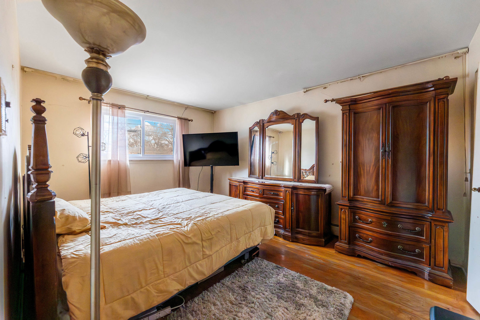 9207 South Halsted Street Chicago, IL 60620 - Photo 8 of 17 a bedroom with a bed and wooden floor