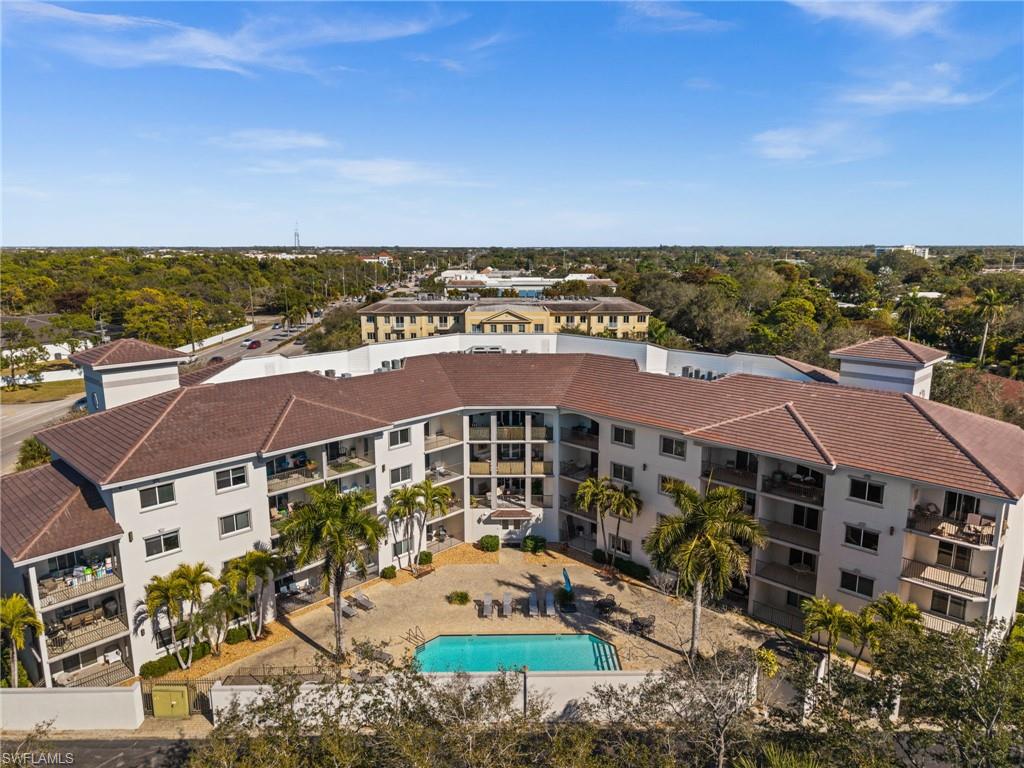 1100 Pine Ridge Road, Unit B103 Naples, FL 34108 - Photo 33 of 38 an aerial view of multiple houses with a yard