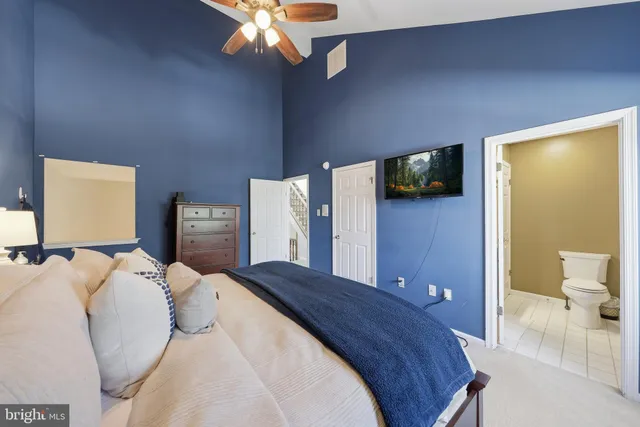 a bedroom with a bed and a tv