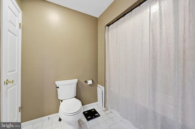 a white toilet sitting next to a small bathroom