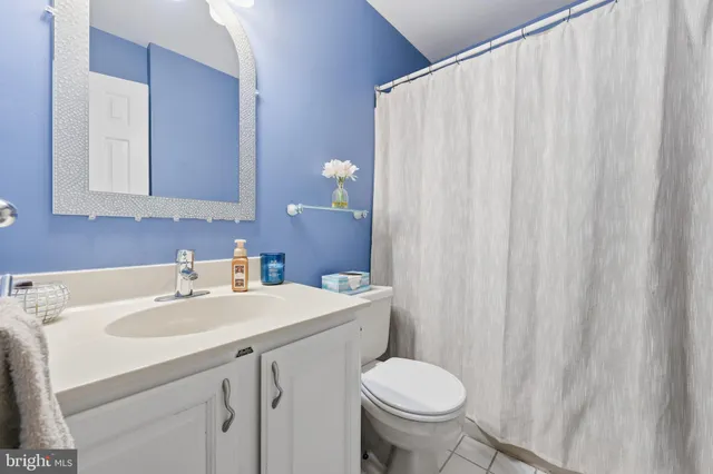 a bathroom with a sink toilet and a mirror