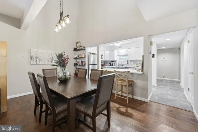 a dining room with furniture and wooden floor