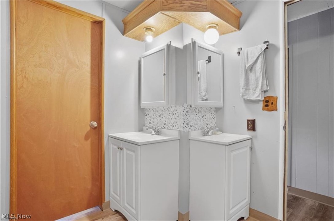 7443 Spillway Road, Unit 73 Lisbon, OH 44432 - Photo 7 of 9 Laundry area with light wood-type flooring and a sink