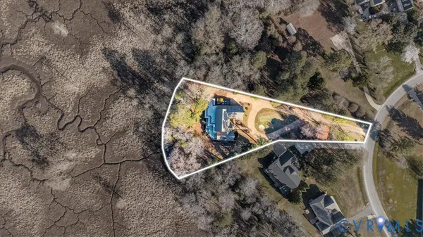 an aerial view of a house with a yard