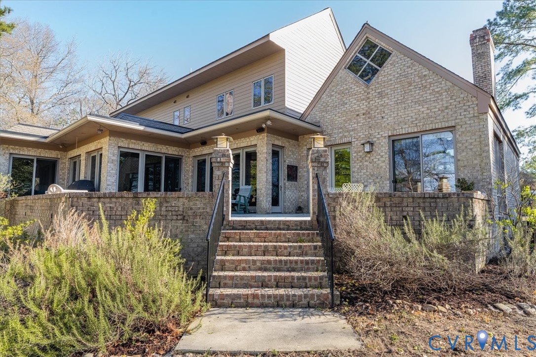 276 Colony Trail Lanexa, VA 23089 - Photo 33 of 39 a front view of a house with a garden