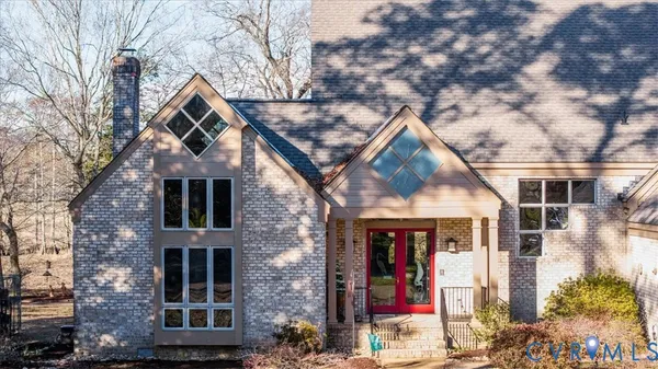 a front view of a house with a tree