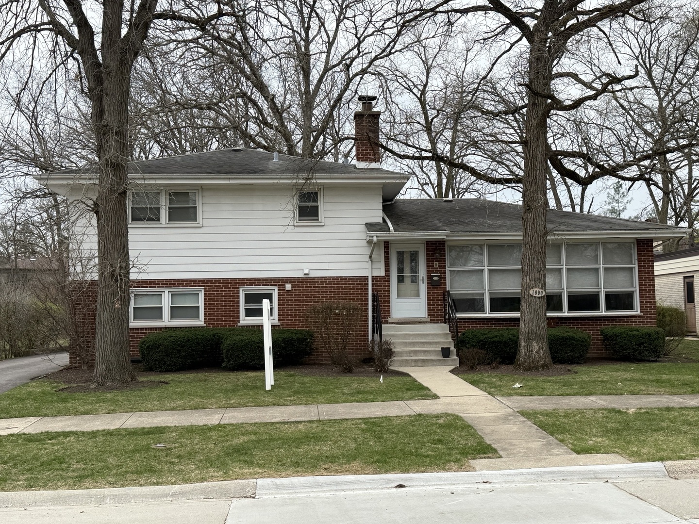 1690 Edgewood Road Highland Park, IL 60035 - Photo 1 of 3 a view of a house with a patio and a garden