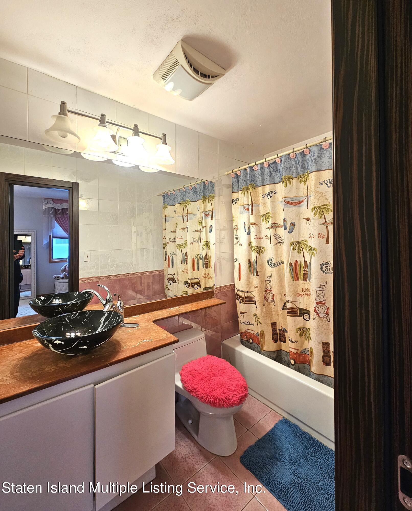 142 Commodore Drive Staten Island, NY 10309 - Photo 23 of 26 a kitchen with a sink and a stove