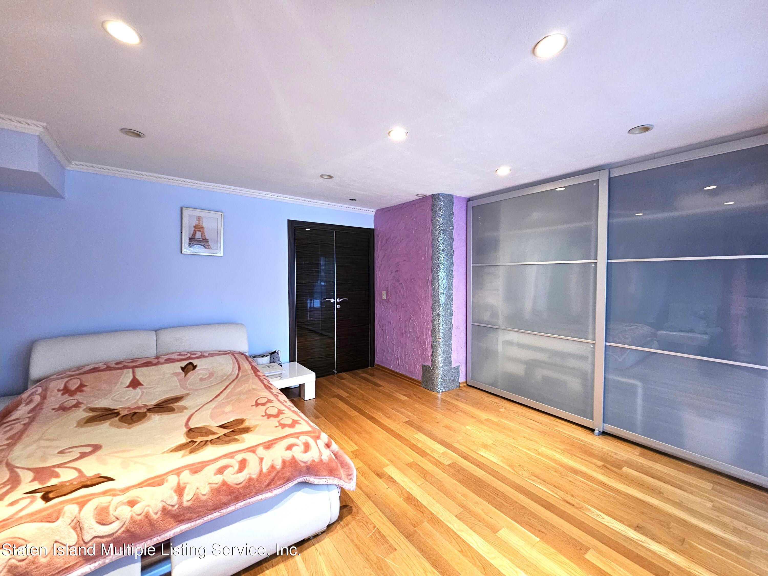 142 Commodore Drive Staten Island, NY 10309 - Photo 6 of 26 a bedroom with a bed and a view of bathroom