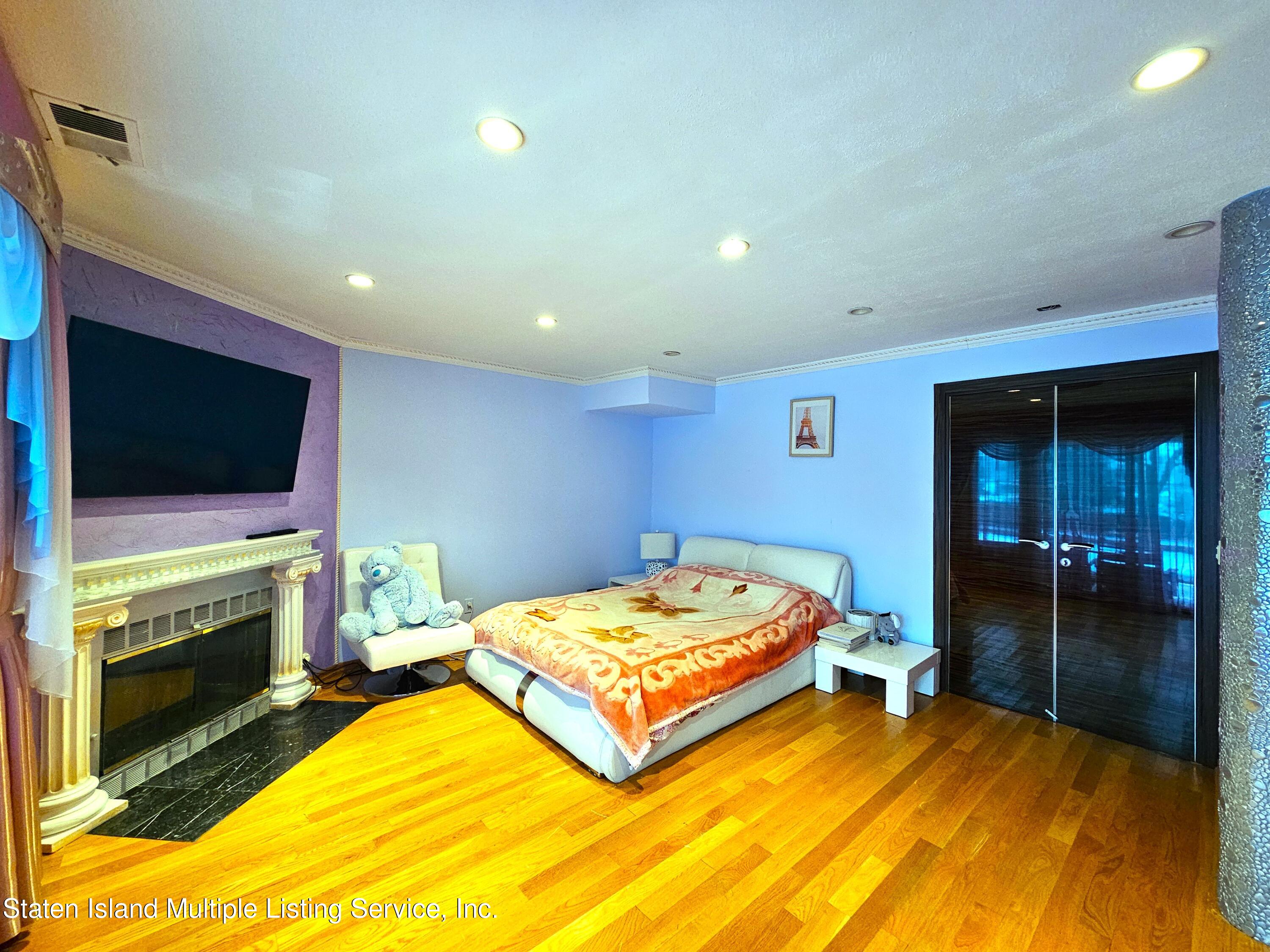 142 Commodore Drive Staten Island, NY 10309 - Photo 7 of 26 a bedroom with a bed and a flat screen tv