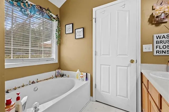a bathroom with a bathtub and a window