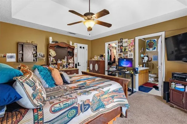 a bed room with furniture and a flat screen tv