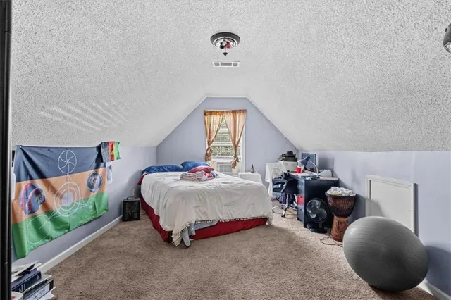 a bedroom with bed and a chandelier