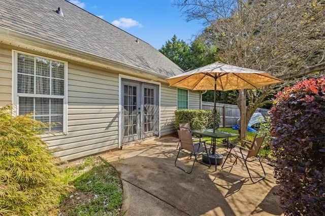 a view of a chair and table in the back yard