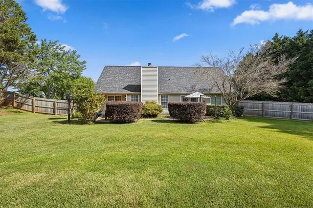 a view of a house with backyard and a garden