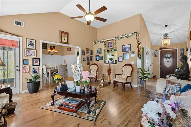 a living room with lots of furniture and lots of equipment