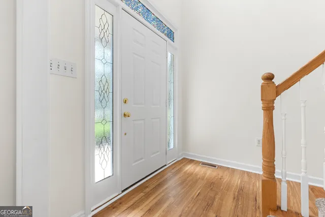an empty room with windows and fireplace