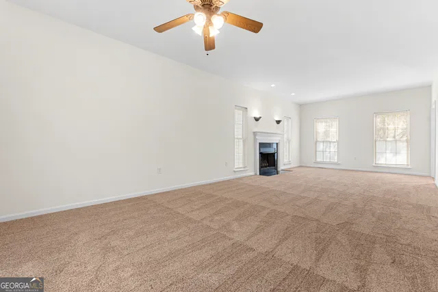 a large kitchen with stainless steel appliances granite countertop a stove a sink dishwasher and a refrigerator with wooden floor