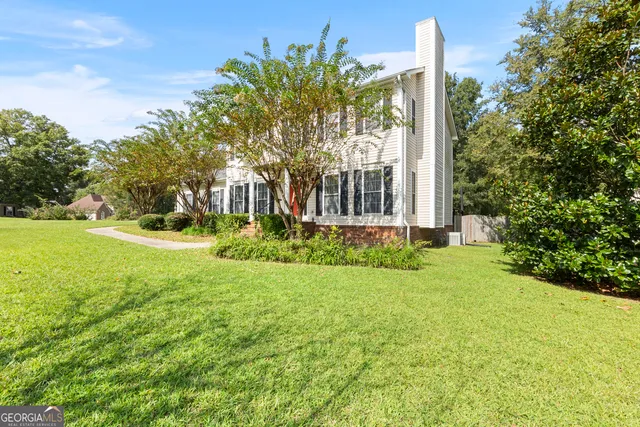 a front view of a house with garden