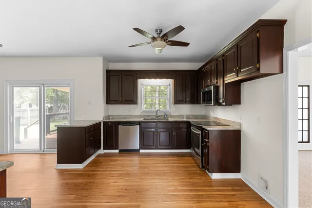 a view of empty room with cabinet and wooden floor