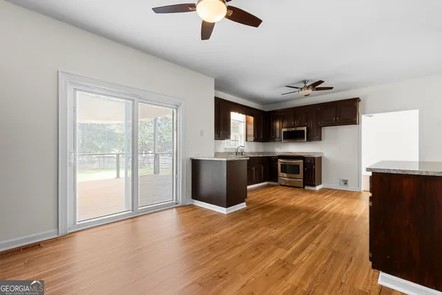 a view of an empty room with a fireplace and a window
