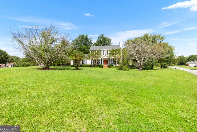 a house view with swimming pool in front of it