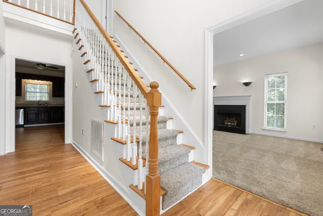 an empty room with a chandelier fan and closet area