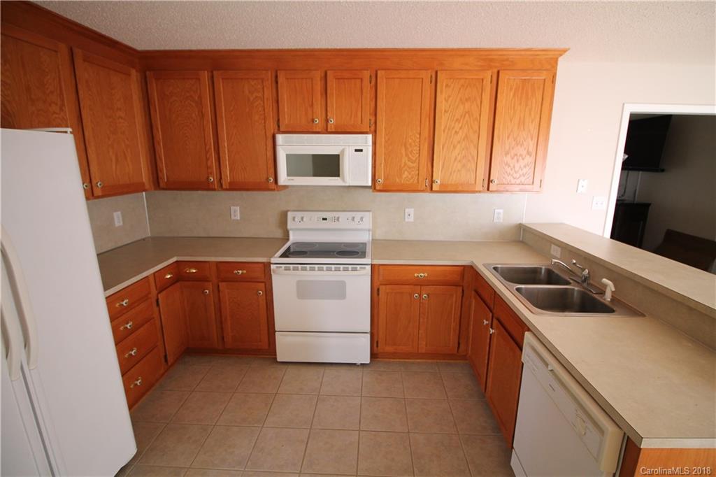 1215 Micol Road Newton, NC 28658 - Photo 3 of 12 a kitchen with a sink stove and microwave
