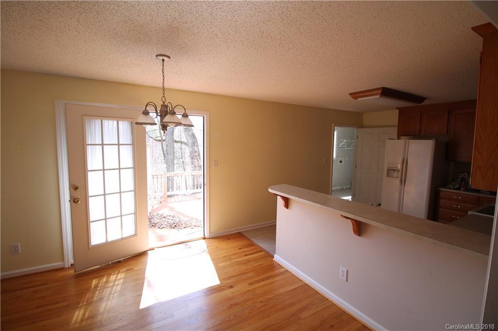 1215 Micol Road Newton, NC 28658 - Photo 7 of 12 a view of a kitchen with a sink wooden floor and a window