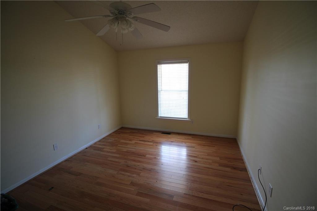 1215 Micol Road Newton, NC 28658 - Photo 9 of 12 a view of an empty room with wooden floor and a window