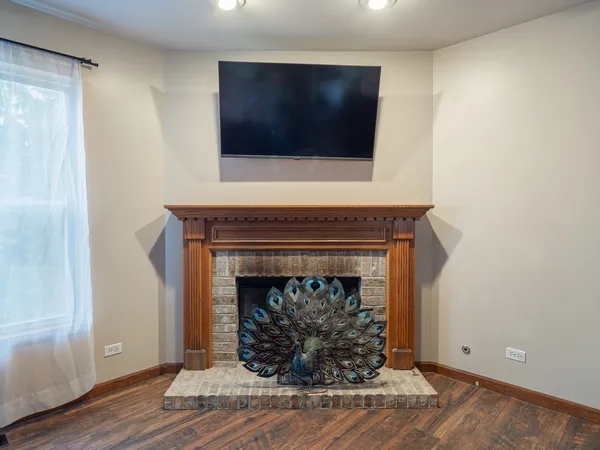 a living room with a fireplace and a flat screen tv