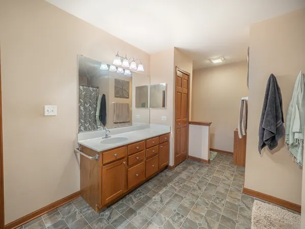 a bathroom with a double vanity sink and mirror