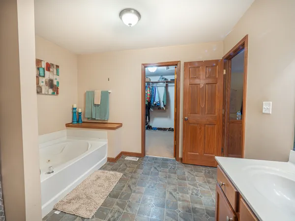 a bathroom with a tub sink and shower