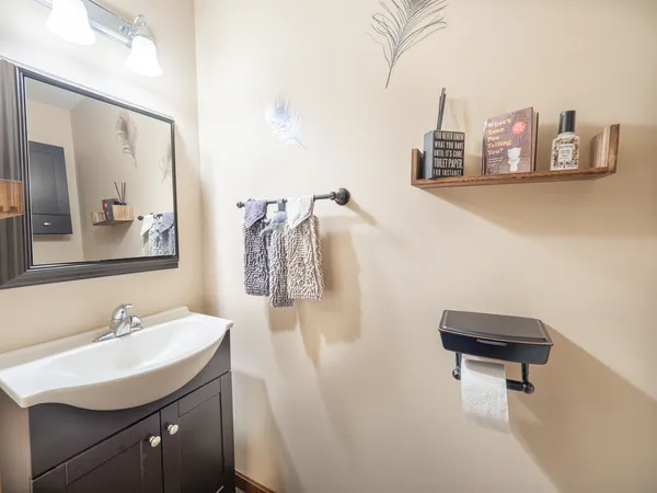 a bathroom with a sink a toilet and a mirror