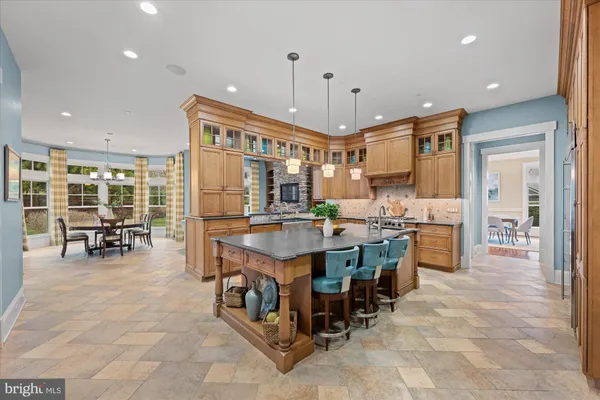 a large kitchen with lots of counter space and furniture
