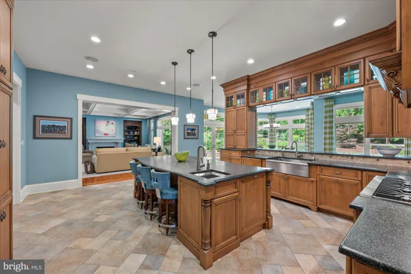 a kitchen with stainless steel appliances granite countertop a sink and a stove