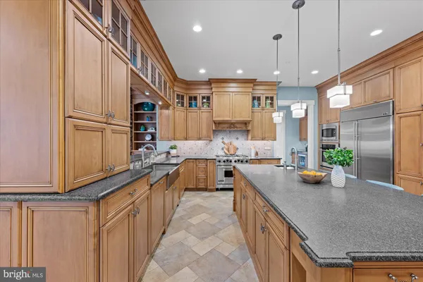 a kitchen with stainless steel appliances granite countertop a sink and stove