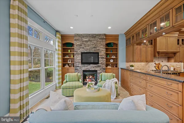 a living room with fireplace furniture and a flat screen tv