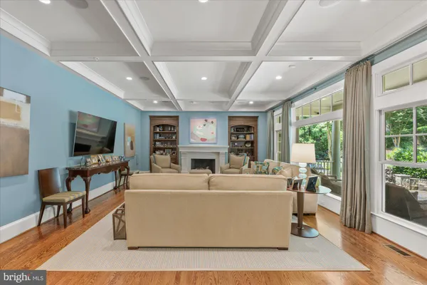 a living room with furniture a large window and a flat screen tv