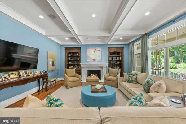 a living room with fireplace furniture and a flat screen tv