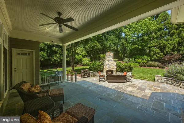 a view of a patio with couches chairs and a big yard
