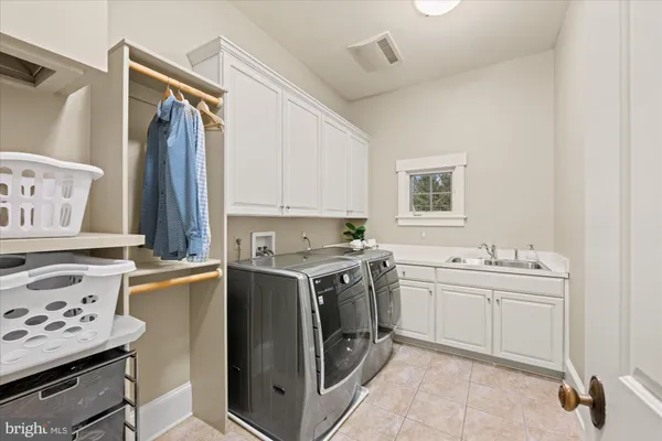 a view of cabinets a sink and a stove in a room