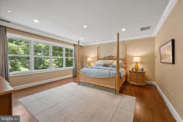 a spacious bedroom with a large bed and a large window