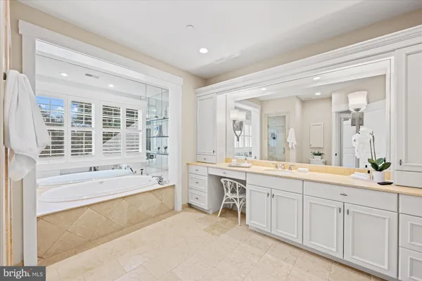a large bathroom with a large tub and double vanity