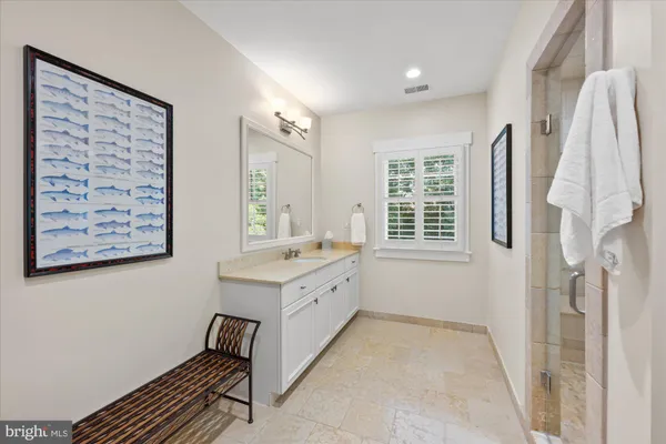 a bathroom with a sink mirror and a bathtub