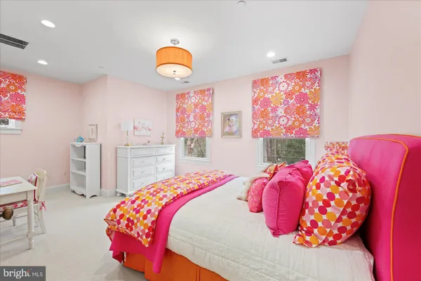 a bedroom with a bed and painting on the wall