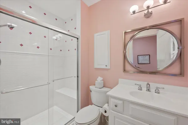 a white toilet sitting next to a bathroom sink